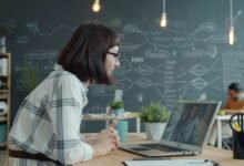 A professional woman uses cloud telephony on her laptop for business communication with a client in an office.